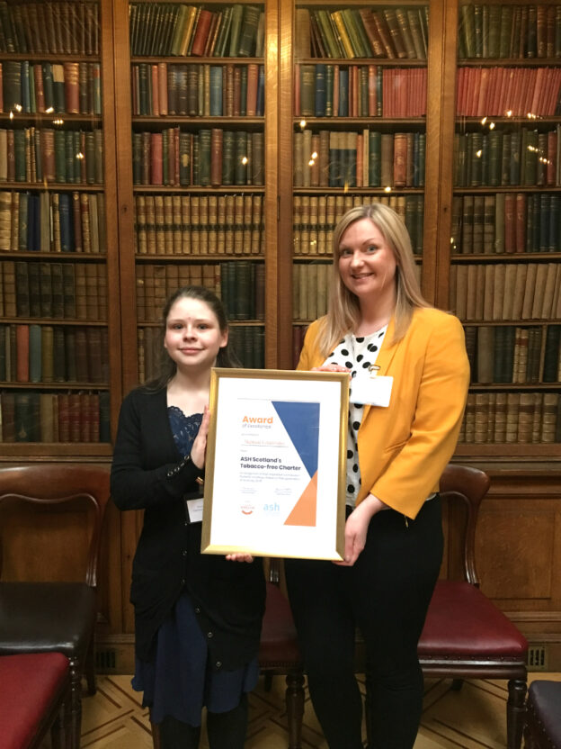 Photo of Eve and Shannon in the Royal College of Physicians library in Edinburgh with their award
