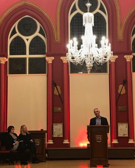 Councillor Karl Rosie speaks to an audience at the Inverness Town House